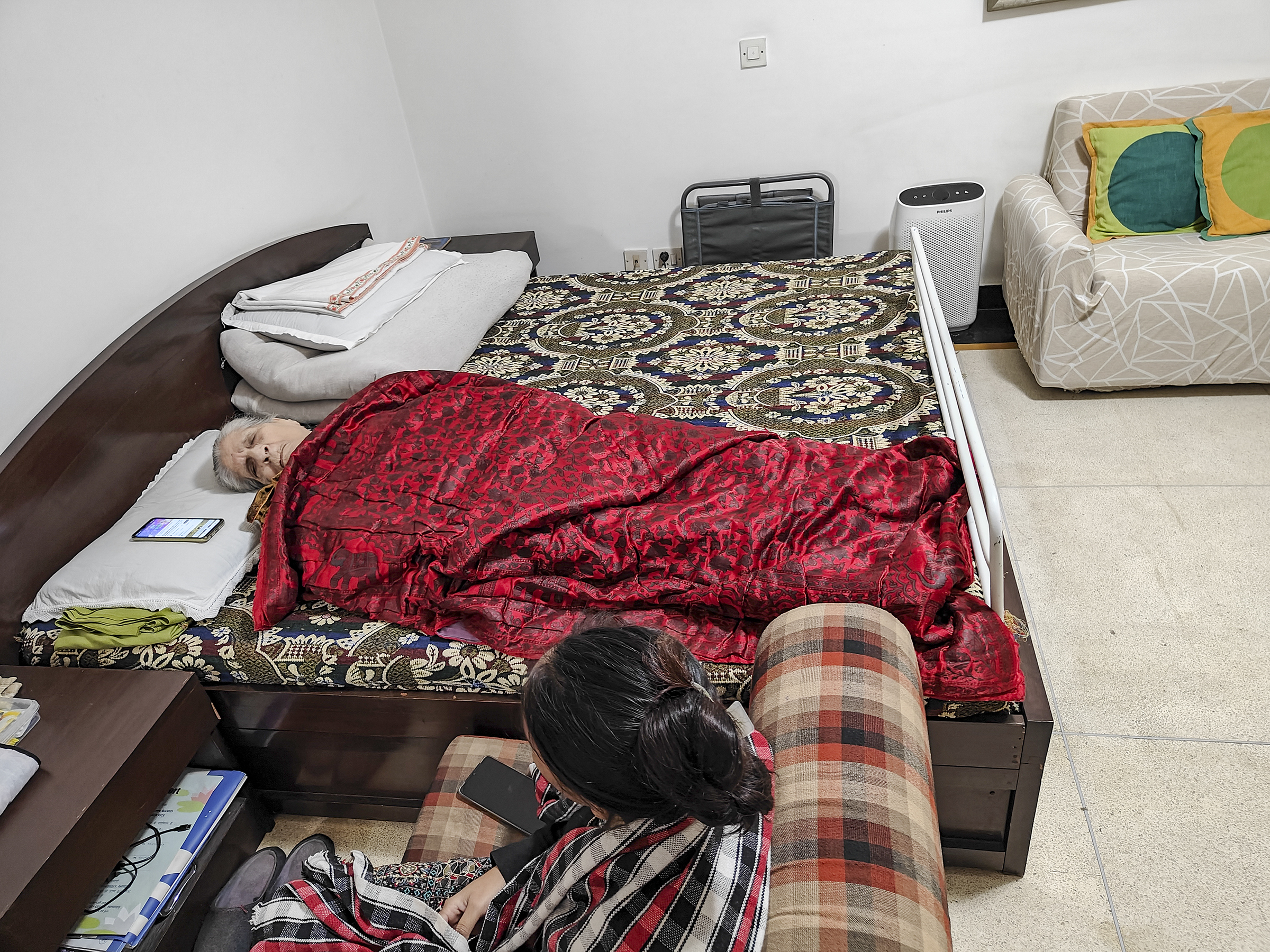 Ma in her bed, in her room with attendant Rashmi